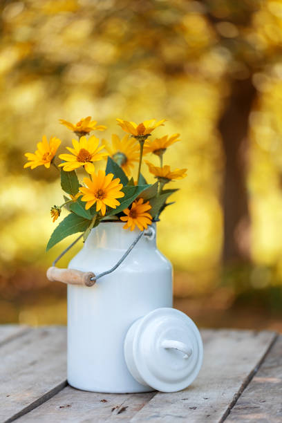istock Yellow flower on old wooden table 1224797699