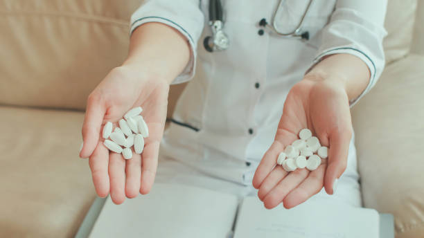 istock A female doctor in her hands holds many white pills 1224800652