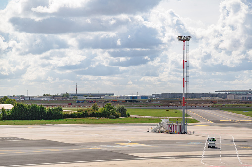 Empty airfield with control tower on it and riding small company car