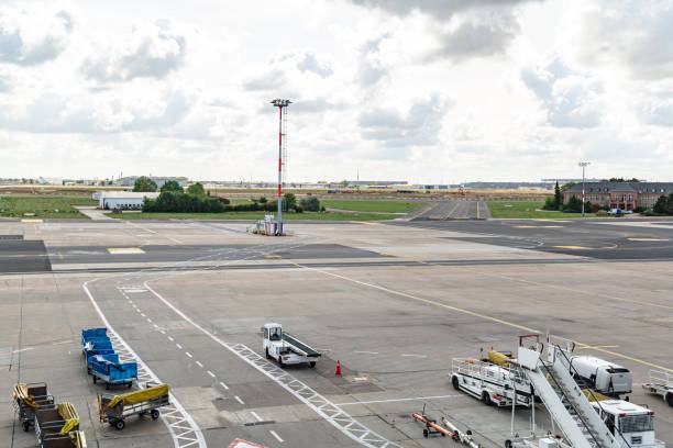 istock Airport runway with vehicles and loaders on it 1224800890