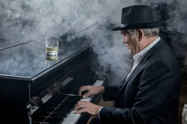Senior Gangster man playing the piano in a jazz club setting