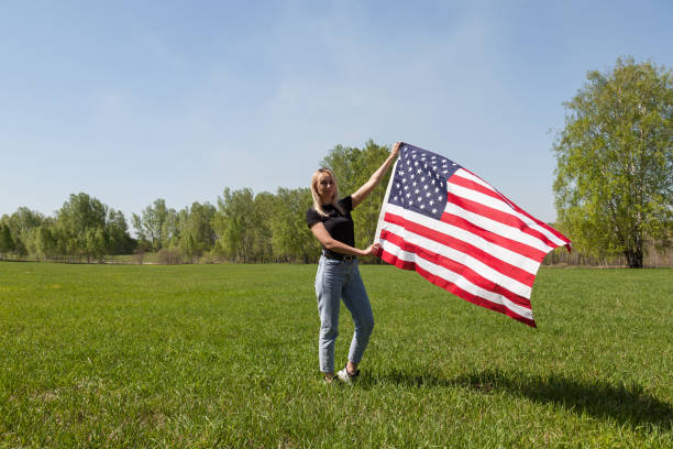 istock Woman Outdoors with American Flag 1224803954