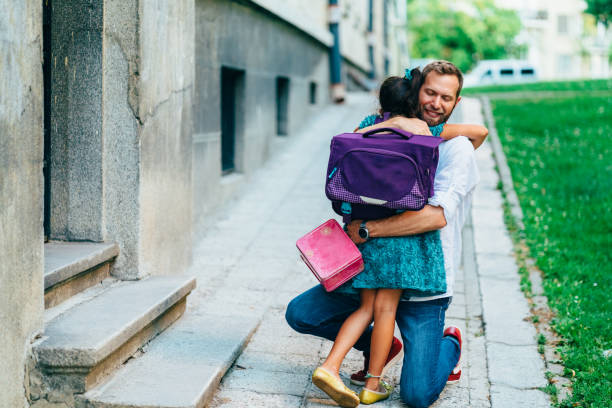istock Little girl hugging her father before going to school 1224804563