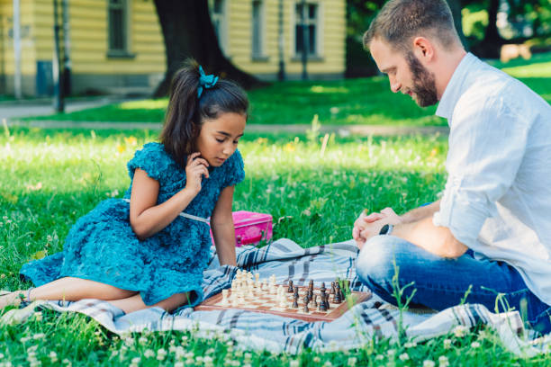 istock Young father playing chess with his daughter 1224804609