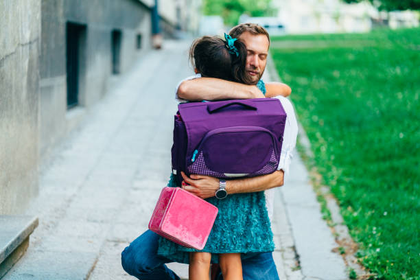 istock Little girl hugging her father before going to school 1224804767