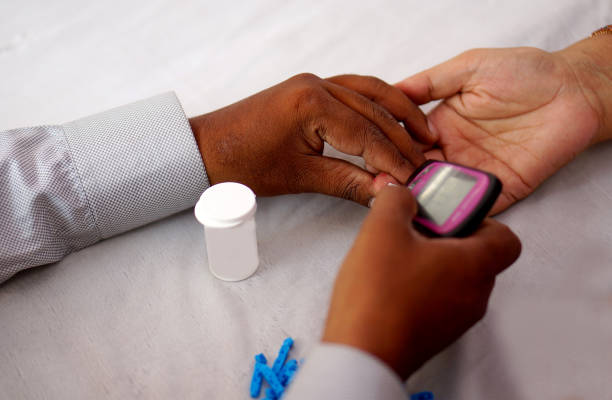 istock Doctor check blood sugar level of a patient with meter 1224804893