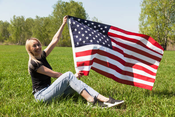istock Woman Outdoors with American Flag 1224804921