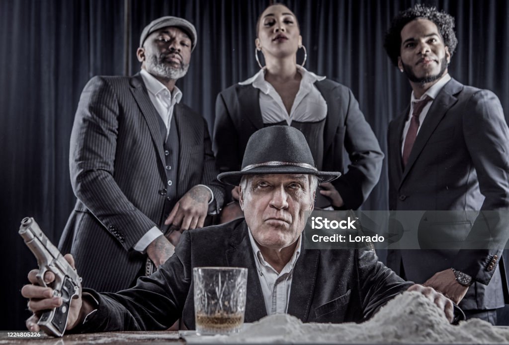 Senior Gangster Man Sitting In A Luxury Chair With Other Gang Members Stock  Photo - Download Image Now - iStock
