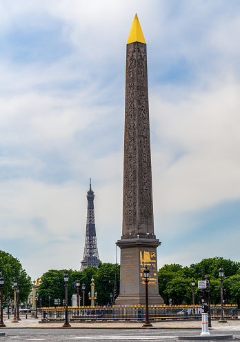 View of the Luxor Obelisk and Eiffel tower from the place de la Concorde - Paris, France.