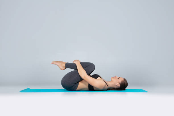 Beautiful woman doing sport exercises on mat stock photo