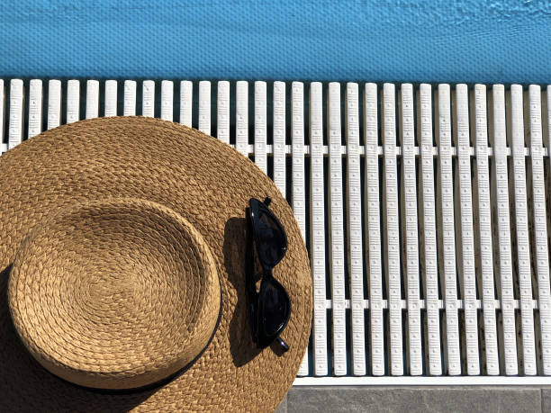 istock Straw hat and sunglasses along the poolside. Copy space. Summer concept. Top view. Vacation concept 1224807259