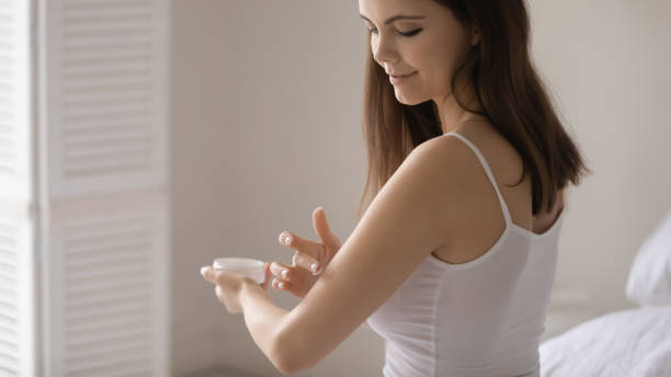 istock Young woman apply moisturizing cream on arm 1224807970