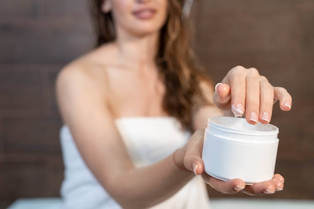 istock Beautiful young woman applying body lotion. 1224808506