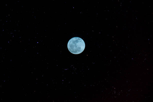 istock The blue moon in the night with stars on the sky. 1224809821