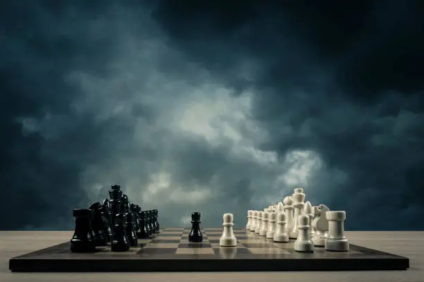 Photo of chess opening in front of storm clouds
