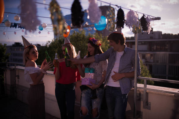 istock Four young people partying on the rooftop 1224814217