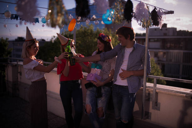 istock Four young people partying on the rooftop 1224814246