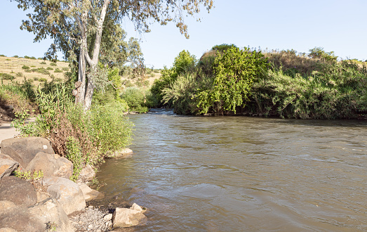 The wide, full-flowing Jordan River flows in the Golan Heights in northern Israel