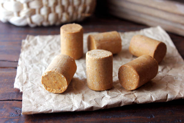 Peanut candy (paçoca or pacoca) traditional Brazilian sweet based on peanuts, manioc flour and sugar on a rustic wooden table