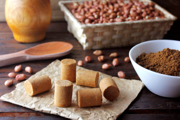 Peanut candy (paçoca or pacoca) traditional Brazilian sweet based on peanuts, manioc flour and sugar on a rustic wooden table