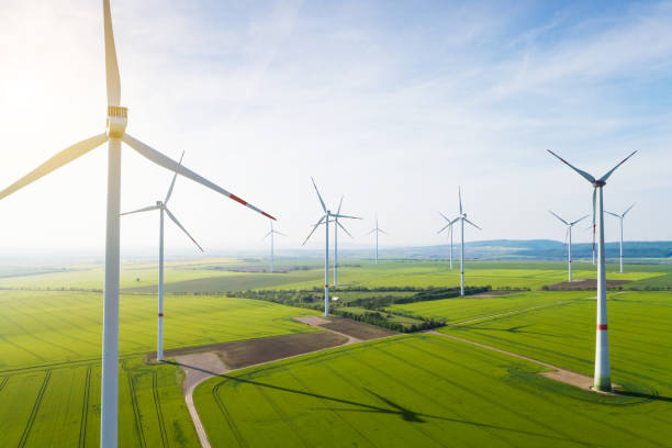 Aerial view of wind turbines and agriculture field Aerial view of wind turbines and agriculture field climate action photos stock pictures, royalty-free photos & images