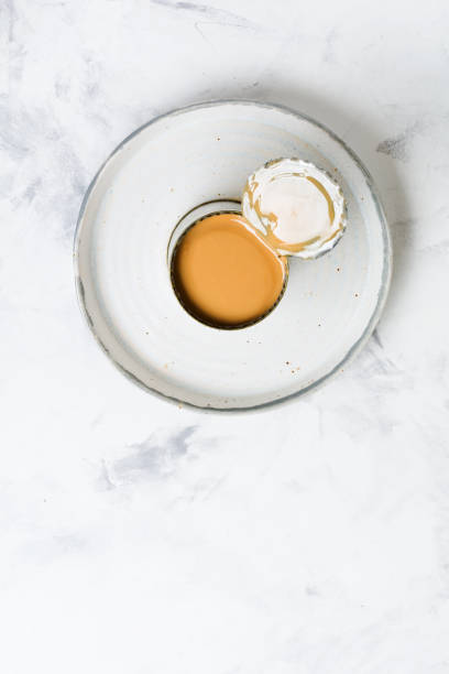 istock Condensed or evaporated milk in open tin on light concrete table. Top view. 1224819935
