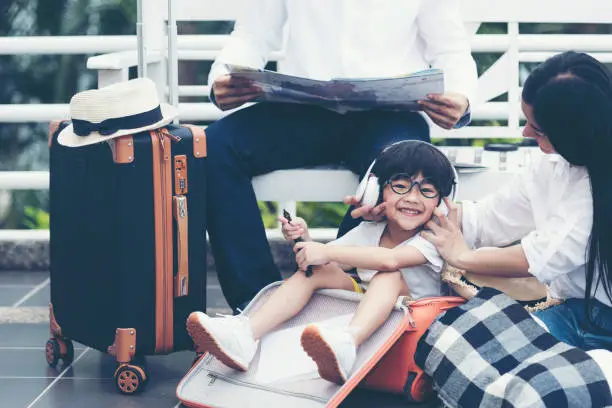 Happy family planning travel in summer vacation. Asia young people lifestyle packing bag luggage and enjoy fun and relax leisure destination in holiday. Travel and Family Concept