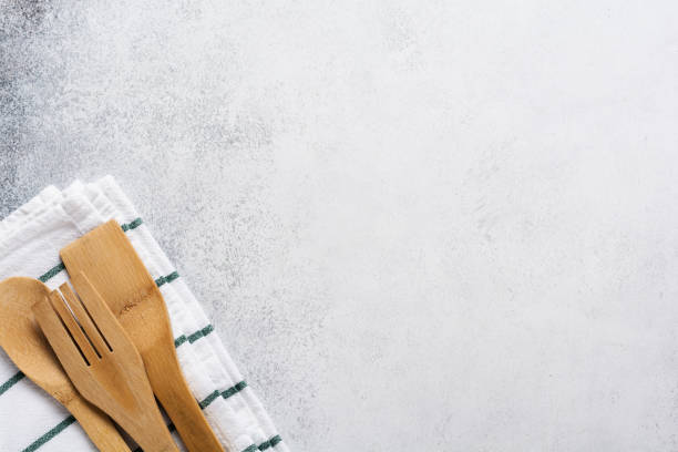 istock Kitchen bamboo tools fork and spoon on linen napkin on a gray concrete old background. Cooking concept. Top view. 1224821538