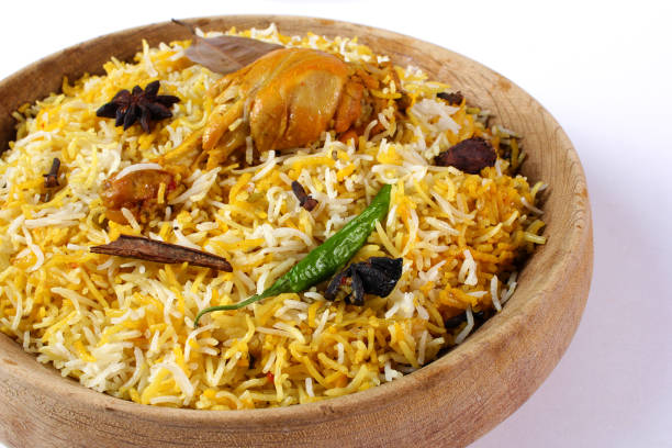 Delicious spicy chicken biryani in traditional bowl on White background, Indian or Pakistani famous masala rice food. Potato and meat are main ingredients of this recipe | Best Ramadan iftar meal.