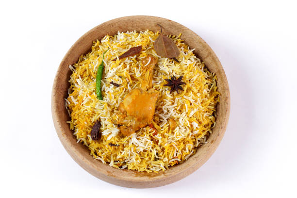 Delicious spicy chicken biryani in traditional bowl on White background, Indian or Pakistani famous masala rice food. Potato and meat are main ingredients of this recipe | Best Ramadan iftar meal.