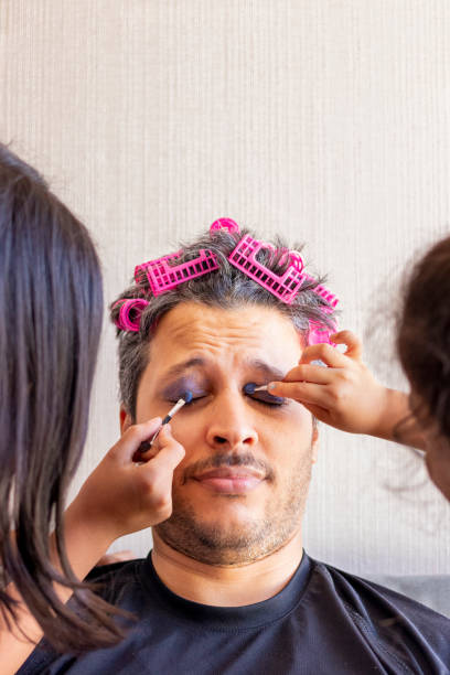 istock Handsome father is being makeup by the hands of his daughters 1224826538