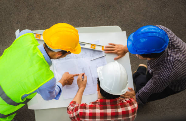 istock Team of Architect engineer planning group project partners meeting at building site, Construction site office teamwork concept 1224827419