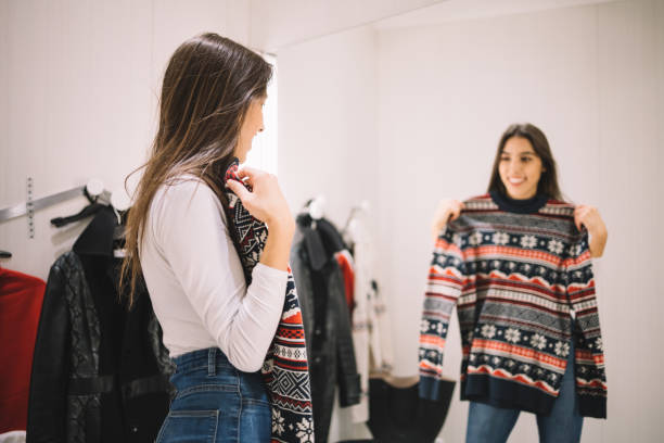 istock Mirror reflection of smiling girl with sweater 1224829656