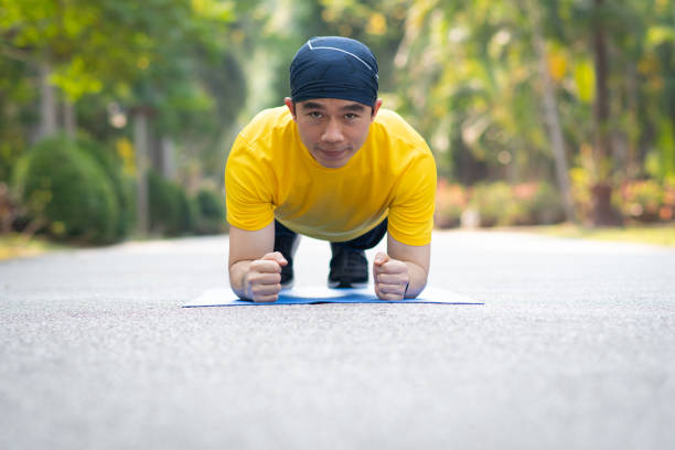 istock Young asian men doing plank exercise outdoors 1224829659