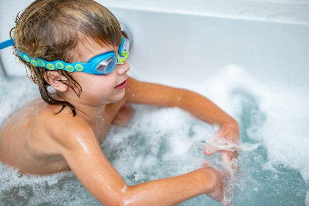 istock Little boy plays in bathtub 1224829913
