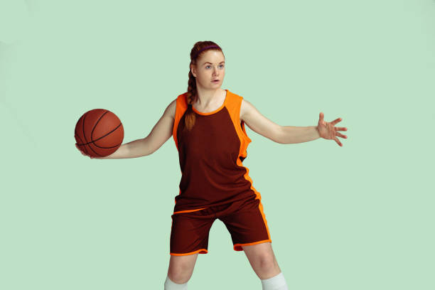 istock Young caucasian female basketball player against mint colored studio background 1224830302