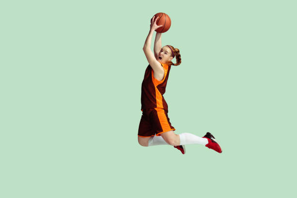 istock Young caucasian female basketball player against mint colored studio background 1224830331