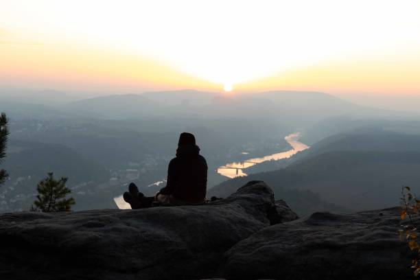 istock Girl watching sunrise Lookout point 1224832212