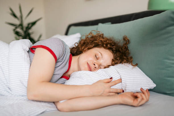 istock Beautiful young woman sleeping peacefully in bed 1224832641