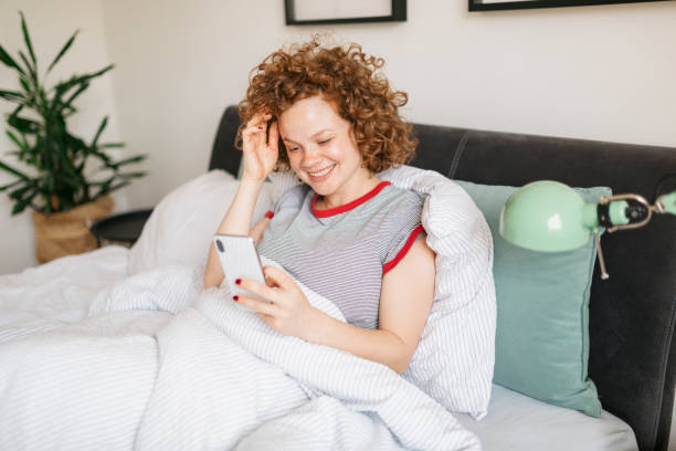 istock Beautiful young woman waking up in bed 1224833098