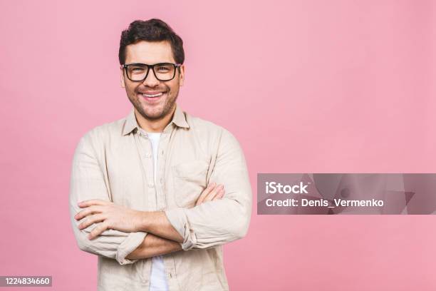 A Portrait Of Young Smiling Handsome Business Man In Casual Shirt Isolated On Pink Background Stock Photo - Download Image Now