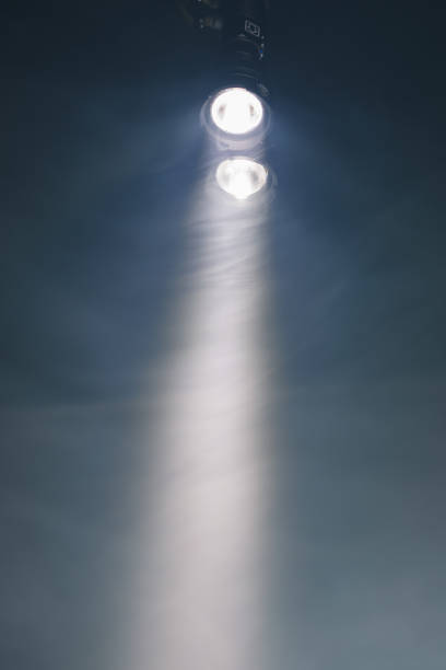 istock ray of double pocket flashlight in smoke, copy-space background 1224836490