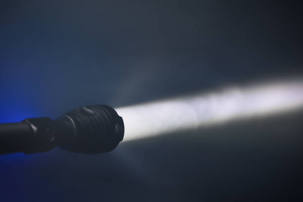 istock ray of pocket flashlight in smoke, copy-space background 1224836576