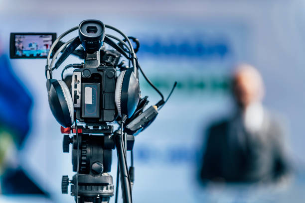 istock Media Event. Camera Recording. Male Speaker On Stage 1224836604