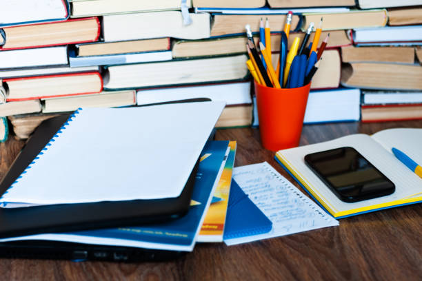 istock Textbook, notebook, laptop computer, mobile phone smartphone, stack of books. Home distance education background, stay home concept 1224836646