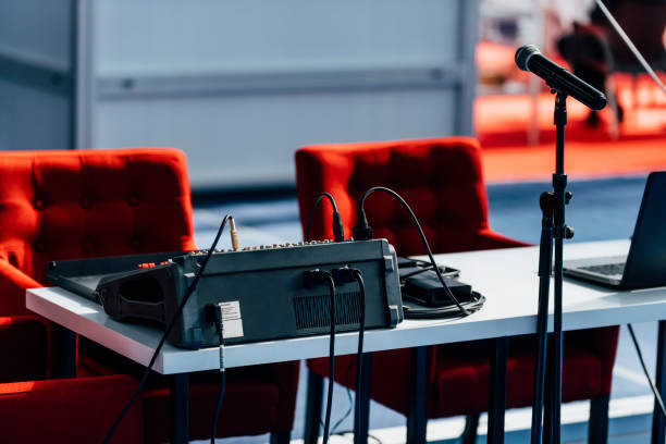 istock Press Conference Hall. Two Red Chairs, Microphone And Sound Mixer 1224836832