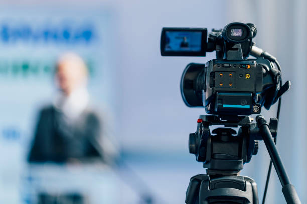 istock Press Conference Event. Cameraman Recording Male Speaker 1224837757