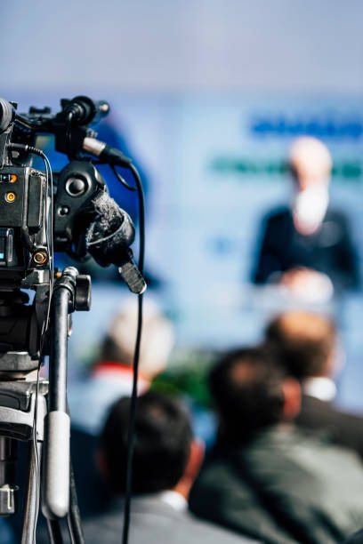 istock Media Event. Camera Recording Male Speaker On Stage 1224837788