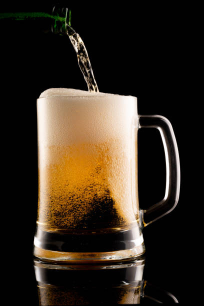 istock glass of beer on black background 1224839577