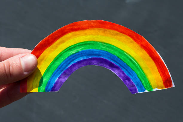 istock hand holds a paper rainbow painted with paints 1224839902